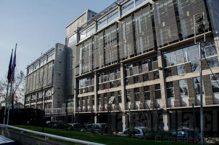 Edificio moderno con persianas metálicas en día soleado.