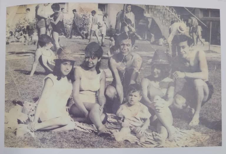 Grupo disfrutando día soleado al aire libre, foto antigua.